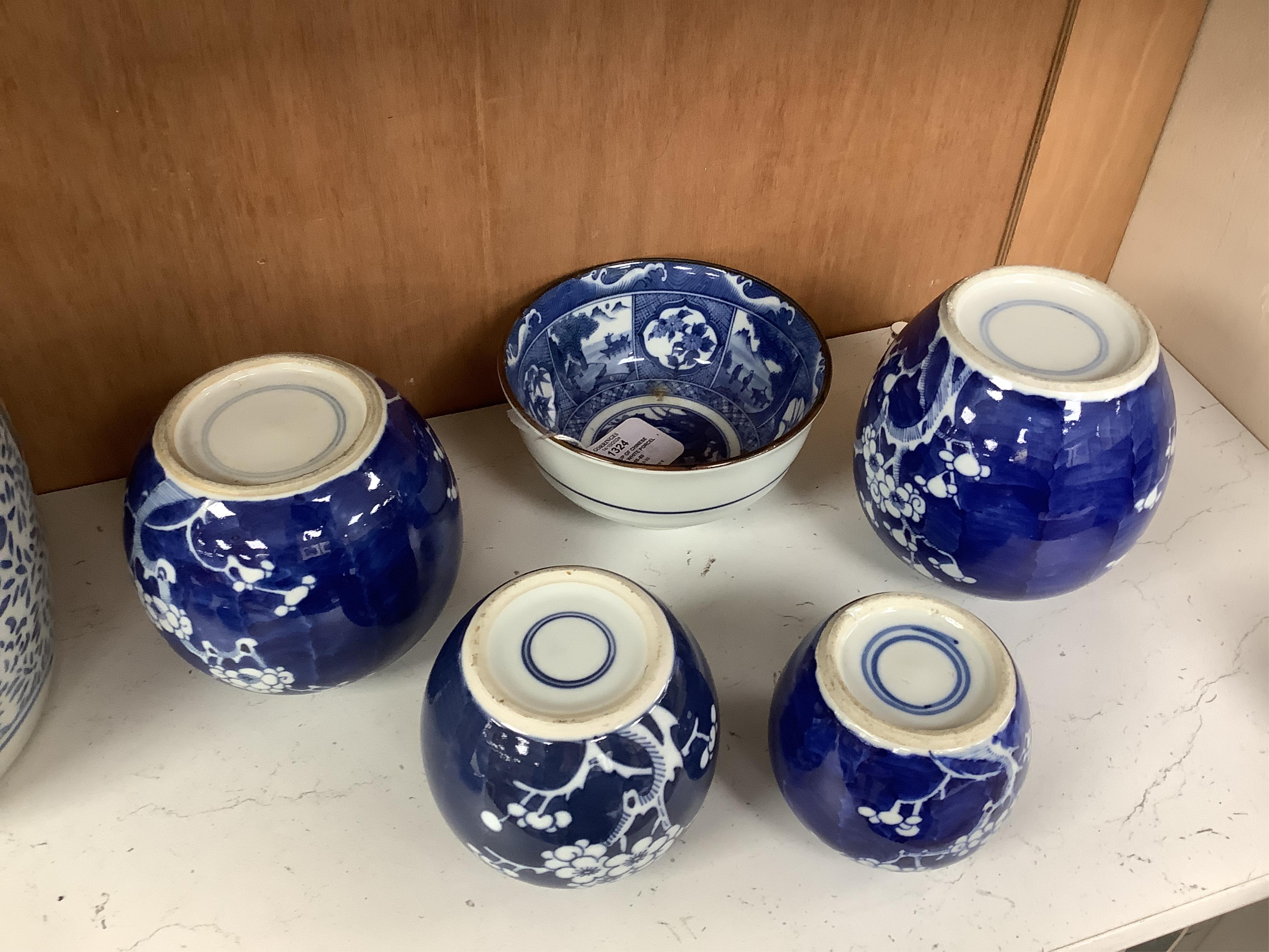 A group of Chinese blue and white porcelain, including a mid 19th century Canton enamel teabowl and a Japanese small dish, tallest 22cm. Condition - fair